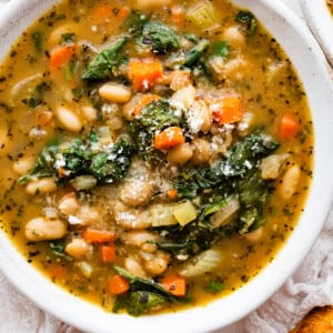 White bean soup in a bowl, garnished with parmesan cheese.